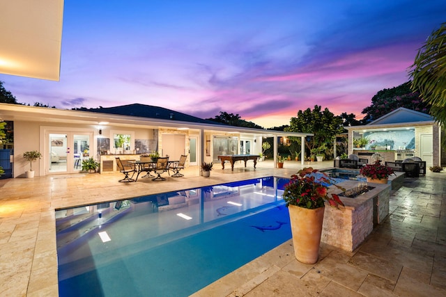 936 Upland Rd, West Palm Beach, FL 33401 - outdoor pool with french doors, area for grilling, and a patio area