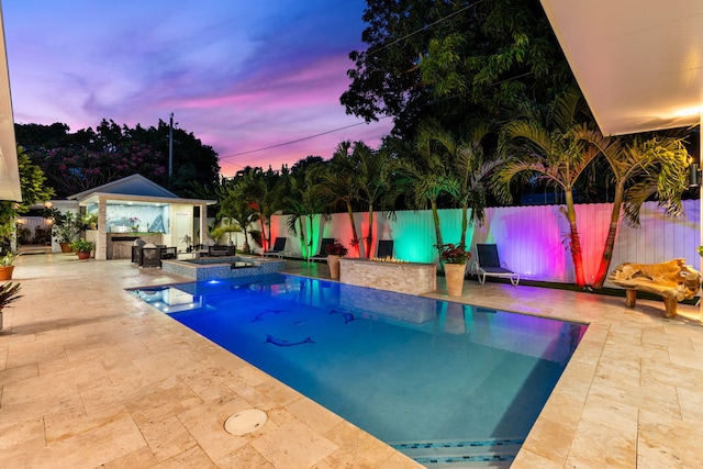 936 Upland Rd, West Palm Beach, FL 33401 - pool at dusk featuring a patio area, a fenced backyard, an outdoor structure, and a pool with connected hot tub