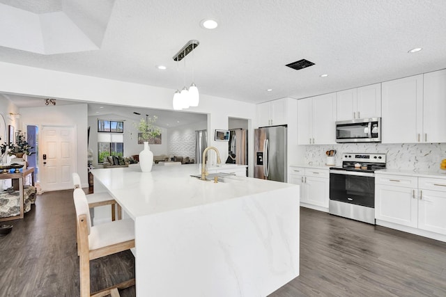 3985 NW 73rd Way, Coral Springs, FL 33065 - kitchen featuring stainless steel appliances, a sink, backsplash, dark wood finished floors, and recessed lighting