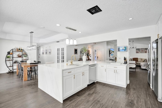 3985 NW 73rd Way, Coral Springs, FL 33065 - kitchen with appliances with stainless steel finishes, a sink, dark wood finished floors, light countertops, and a textured ceiling