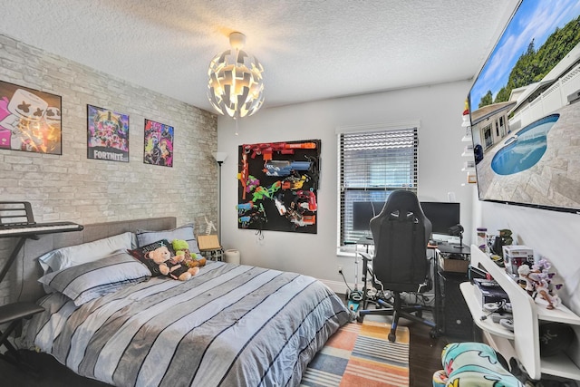 3985 NW 73rd Way, Coral Springs, FL 33065 - bedroom featuring a textured ceiling, a desk, wood finished floors, a chandelier, and brick wall