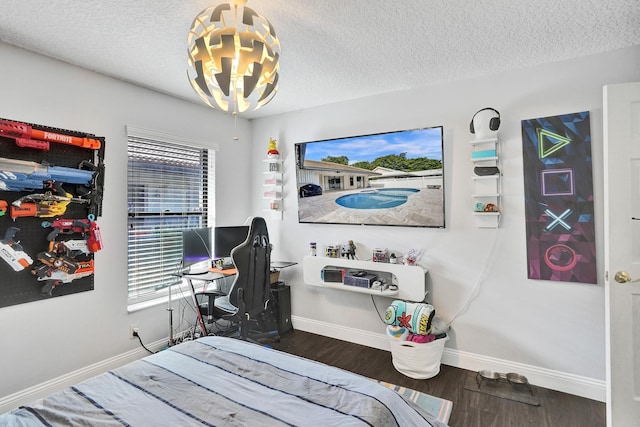 3985 NW 73rd Way, Coral Springs, FL 33065 - bedroom featuring a chandelier, baseboards, a textured ceiling, and wood finished floors
