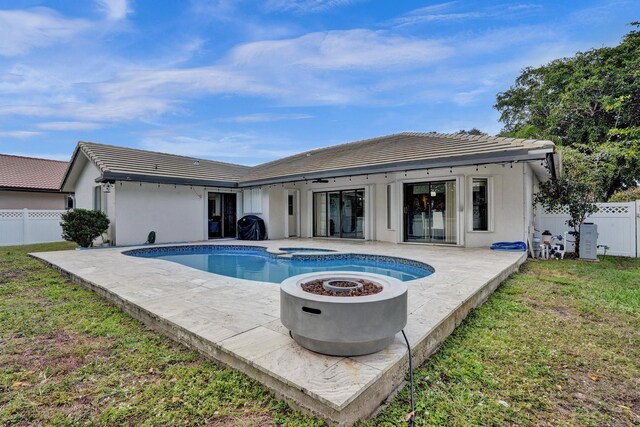3985 NW 73rd Way, Coral Springs, FL 33065 - back of property with a patio area, a tiled roof, stucco siding, and a pool with connected hot tub