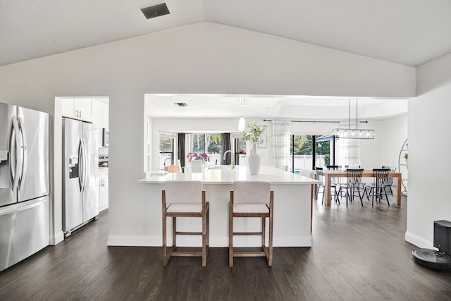 3985 NW 73rd Way, Coral Springs, FL 33065 - kitchen with stainless steel fridge with ice dispenser, vaulted ceiling, white cabinets, a breakfast bar area, and light countertops