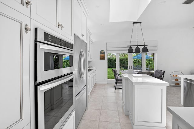 2373 NW 25th Way, Boca Raton, FL 33434 - kitchen with appliances with stainless steel finishes, french doors, pendant lighting, white cabinetry, and light countertops