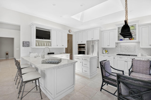 2373 NW 25th Way, Boca Raton, FL 33434 - kitchen with a skylight, appliances with stainless steel finishes, backsplash, a peninsula, and light tile patterned flooring