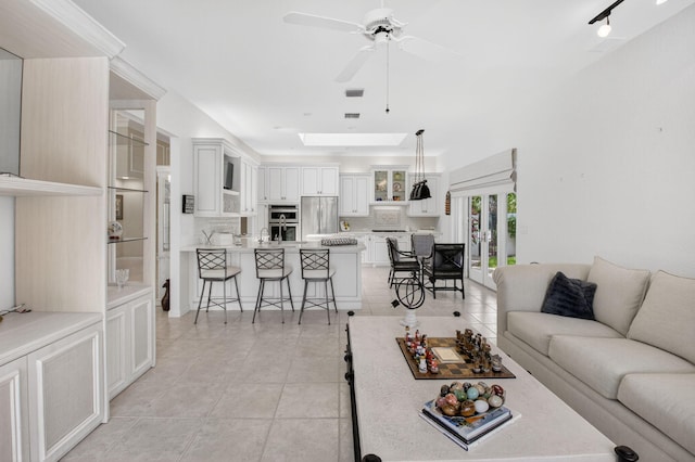 2373 NW 25th Way, Boca Raton, FL 33434 - living room with light tile patterned floors, ceiling fan, and a skylight