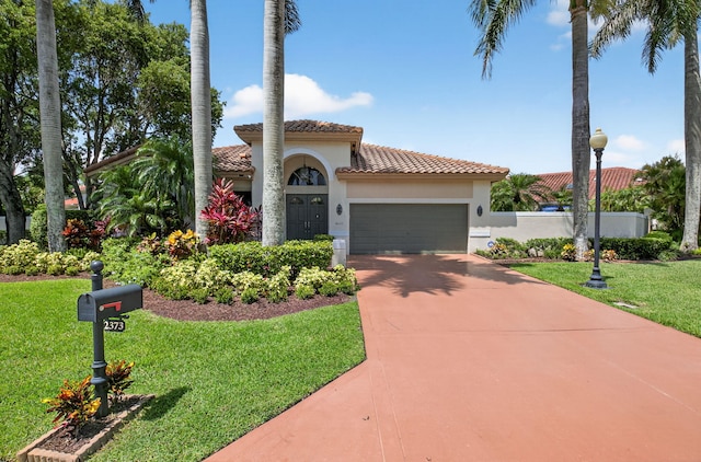2373 NW 25th Way, Boca Raton, FL 33434 - mediterranean / spanish-style house with a tiled roof, stucco siding, a garage, concrete driveway, and a front yard