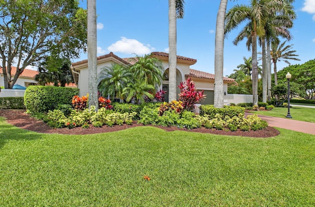 2373 NW 25th Way, Boca Raton, FL 33434 - mediterranean / spanish home with a tile roof, an attached garage, a front lawn, stucco siding, and driveway