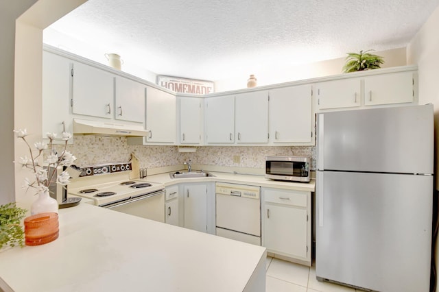 338 Pine Ridge Cir Unit B-1, Greenacres, FL 33463 - kitchen with appliances with stainless steel finishes, under cabinet range hood, a textured ceiling, light countertops, and a sink