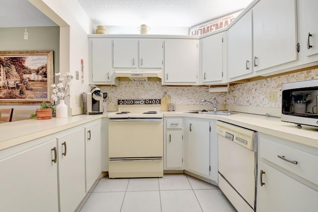 338 Pine Ridge Cir Unit B-1, Greenacres, FL 33463 - kitchen with white appliances, under cabinet range hood, a sink, light tile patterned floors, and light countertops