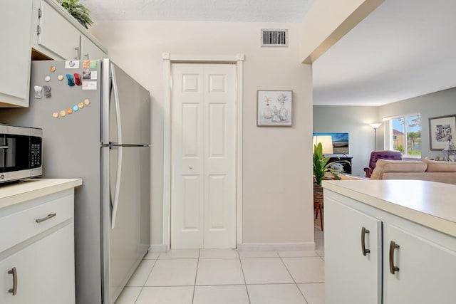338 Pine Ridge Cir Unit B-1, Greenacres, FL 33463 - kitchen with stainless steel appliances, light countertops, light tile patterned floors, open floor plan, and baseboards