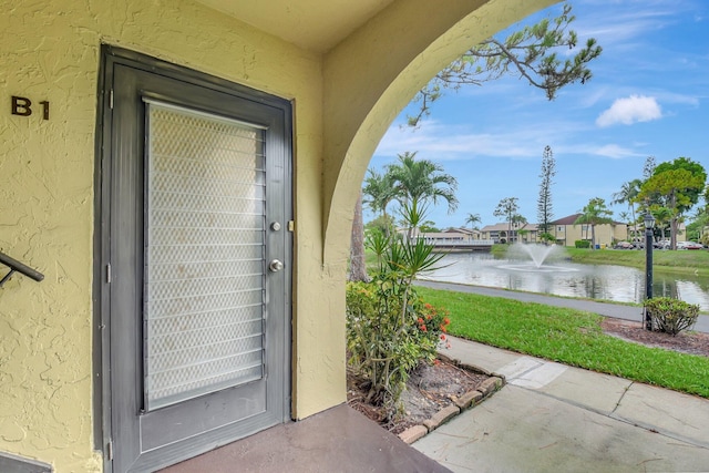 338 Pine Ridge Cir Unit B-1, Greenacres, FL 33463 - property entrance with a water view and stucco siding