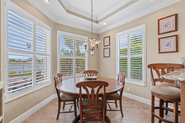 725 Edgebrook Ln, West Palm Beach, FL 33411 - dining area featuring a chandelier, inlaid floor details, light tile patterned flooring, a raised ceiling, and crown molding