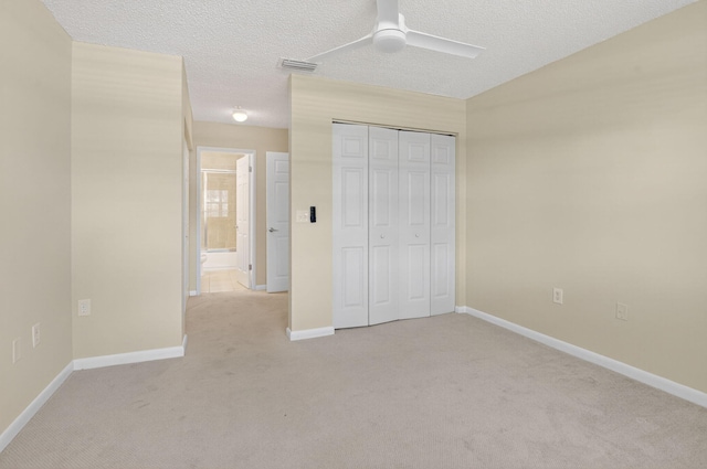 3131 Clint Moore Rd Unit 206, Boca Raton, FL 33496 - unfurnished bedroom featuring light carpet, baseboards, a closet, a ceiling fan, and a textured ceiling