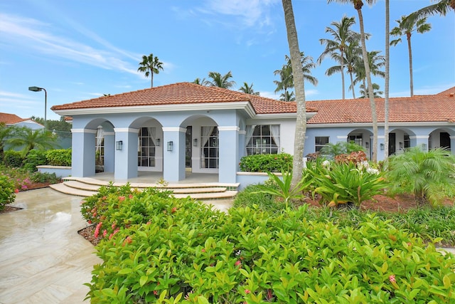 3131 Clint Moore Rd Unit 206, Boca Raton, FL 33496 - view of front facade with a tiled roof, stucco siding, and a porch
