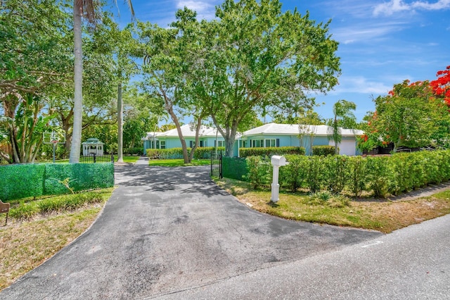 1220 N Swinton Ave, Delray Beach, FL 33444 - view of asphalt driveway with a gated entry