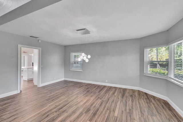 1220 N Swinton Ave, Delray Beach, FL 33444 - unfurnished room with wood finished floors, baseboards, and a chandelier