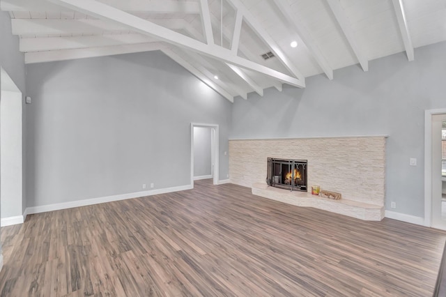 1220 N Swinton Ave, Delray Beach, FL 33444 - unfurnished living room with beamed ceiling, wood finished floors, a fireplace, high vaulted ceiling, and baseboards