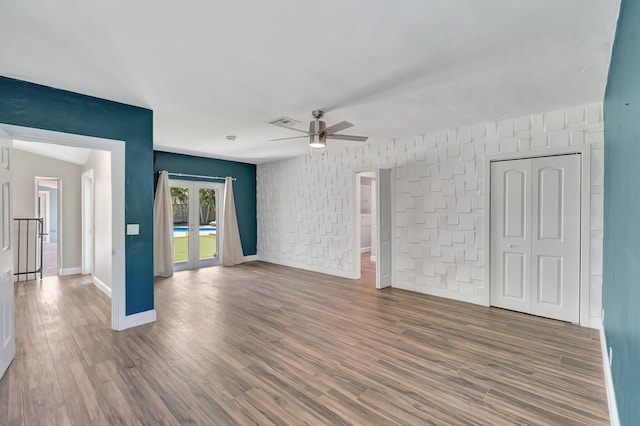 1220 N Swinton Ave, Delray Beach, FL 33444 - unfurnished living room with a ceiling fan, wood finished floors, and baseboards