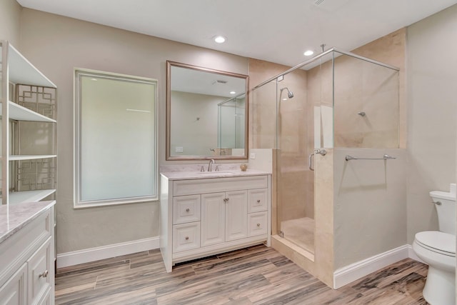 1220 N Swinton Ave, Delray Beach, FL 33444 - bathroom featuring vanity, a shower stall, toilet, wood finished floors, and recessed lighting