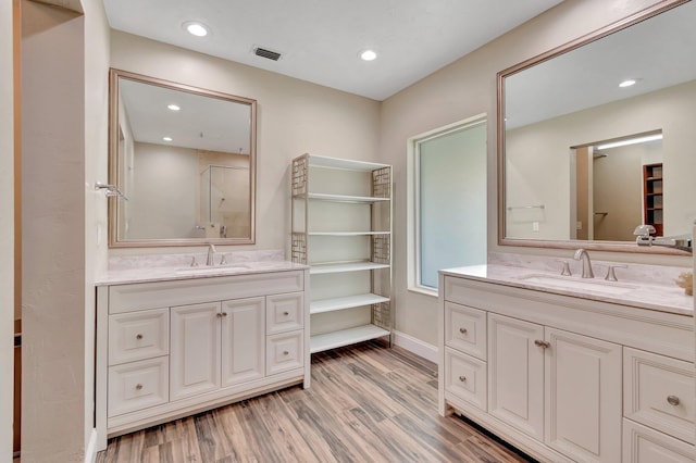 1220 N Swinton Ave, Delray Beach, FL 33444 - bathroom with two vanities, wood finished floors, baseboards, recessed lighting, and a shower