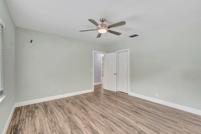 1220 N Swinton Ave, Delray Beach, FL 33444 - unfurnished bedroom with light wood-style flooring, baseboards, a closet, and ceiling fan