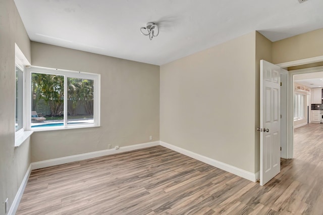 1220 N Swinton Ave, Delray Beach, FL 33444 - empty room with wood finished floors and baseboards