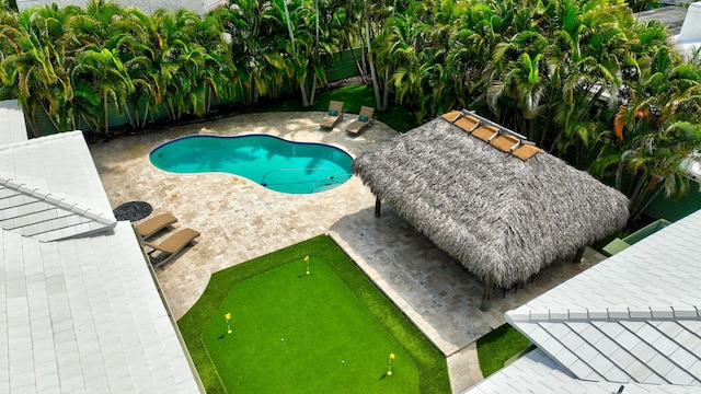 1220 N Swinton Ave, Delray Beach, FL 33444 - swimming pool featuring a putting area, a patio area, and a fenced backyard
