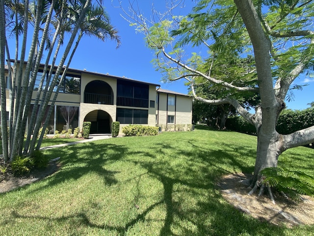 302 Pine Ridge Cir Unit D-1, Greenacres, FL 33463 - rear view of house with a yard and stucco siding