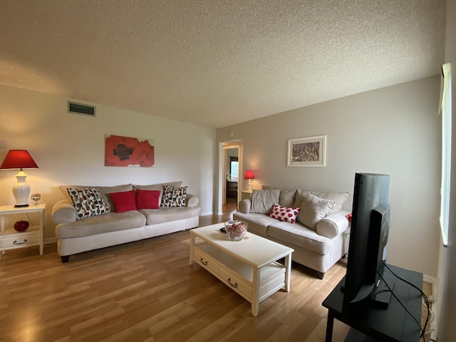 302 Pine Ridge Cir Unit D-1, Greenacres, FL 33463 - living room featuring a textured ceiling and wood finished floors