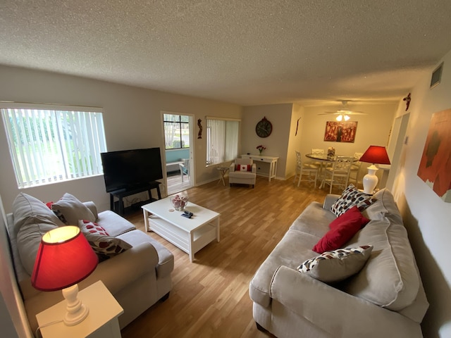 302 Pine Ridge Cir Unit D-1, Greenacres, FL 33463 - living area featuring a textured ceiling, wood finished floors, and a ceiling fan