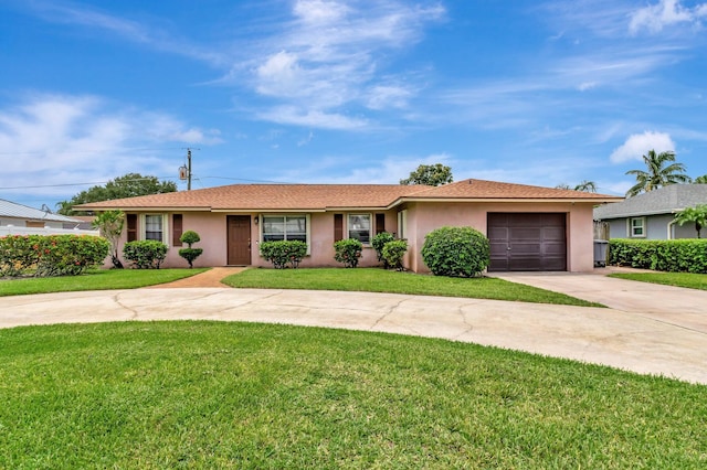 3928 Coelebs Ave, Boynton Beach, FL 33436 - ranch-style home featuring concrete driveway, a garage, stucco siding, and a front lawn