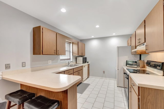 3928 Coelebs Ave, Boynton Beach, FL 33436 - kitchen featuring electric range oven, under cabinet range hood, a peninsula, dishwasher, and light countertops