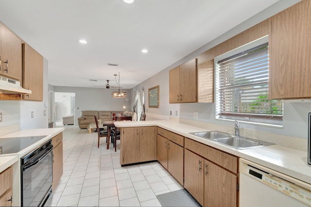 3928 Coelebs Ave, Boynton Beach, FL 33436 - kitchen with white dishwasher, a sink, light countertops, a peninsula, and under cabinet range hood