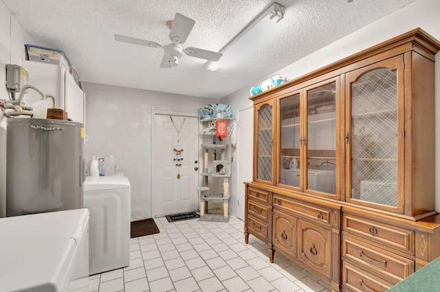 3928 Coelebs Ave, Boynton Beach, FL 33436 - laundry room with washing machine and clothes dryer, electric water heater, a ceiling fan, a textured ceiling, and light tile patterned floors
