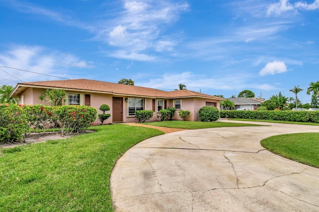 3928 Coelebs Ave, Boynton Beach, FL 33436 - single story home with curved driveway, a front lawn, stucco siding, and a garage