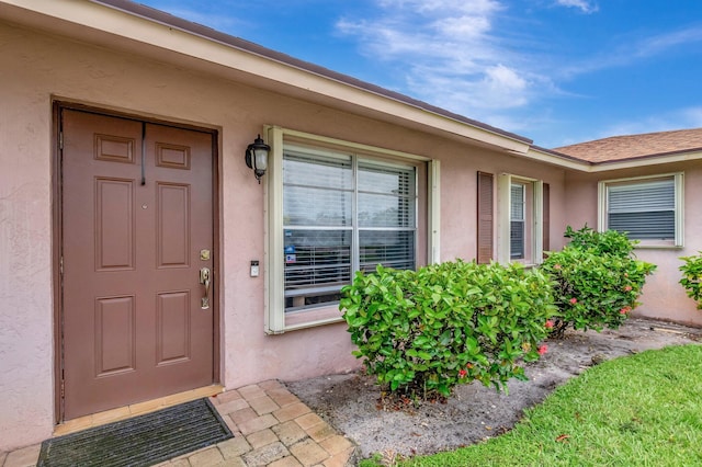 3928 Coelebs Ave, Boynton Beach, FL 33436 - doorway to property with stucco siding