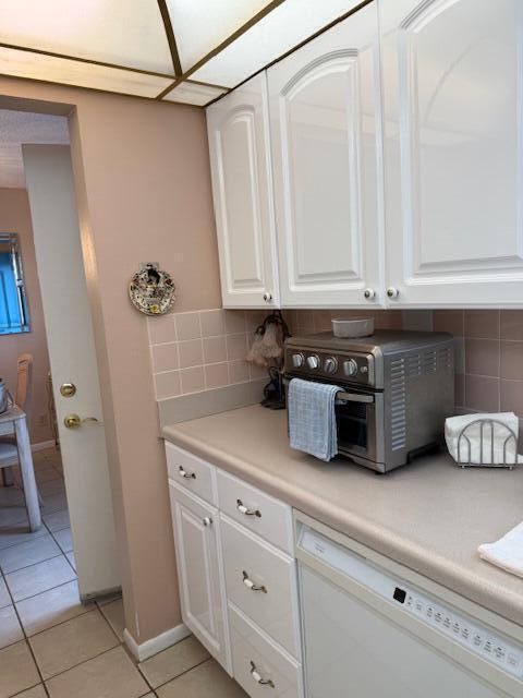725 Lori Dr Unit 313, Palm Springs, FL 33461 - bar area with dishwasher, light tile patterned flooring, and tasteful backsplash