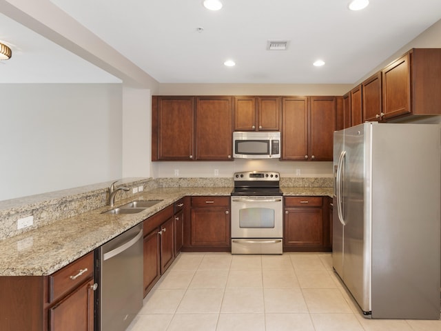 110 W Coda Cir Unit 110, Delray Beach, FL 33444 - kitchen with stainless steel appliances, a sink, light stone countertops, recessed lighting, and light tile patterned flooring