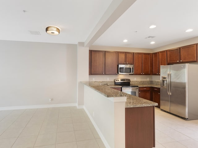 110 W Coda Cir Unit 110, Delray Beach, FL 33444 - kitchen featuring stainless steel appliances, a peninsula, light stone counters, recessed lighting, and baseboards