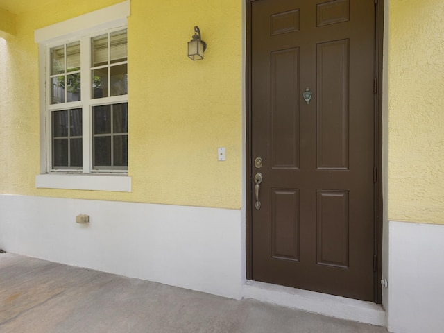 110 W Coda Cir Unit 110, Delray Beach, FL 33444 - view of exterior entry with stucco siding and covered porch