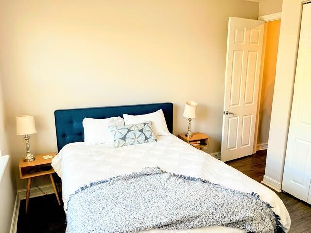 110 W Coda Cir Unit 110, Delray Beach, FL 33444 - bedroom with baseboards and dark wood-type flooring