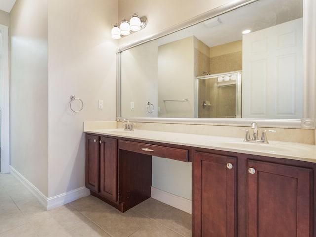 110 W Coda Cir Unit 110, Delray Beach, FL 33444 - bathroom featuring a stall shower, double vanity, tile patterned flooring, and baseboards