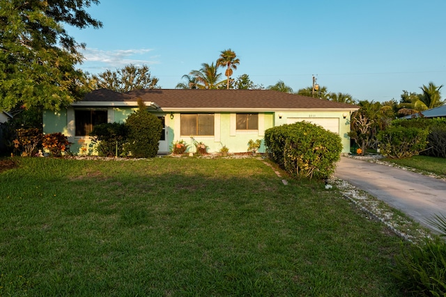 2511 SE Marius St, Port Saint Lucie, FL 34953 - single story home featuring a garage, a front yard, driveway, and stucco siding