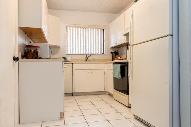 2511 SE Marius St, Port Saint Lucie, FL 34953 - kitchen featuring white appliances, a sink, light countertops, white cabinets, and light tile patterned floors