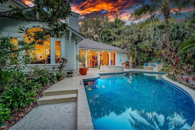 6000 Eagles Nest Dr, Jupiter, FL 33458 - pool at dusk featuring a patio area and an outdoor pool