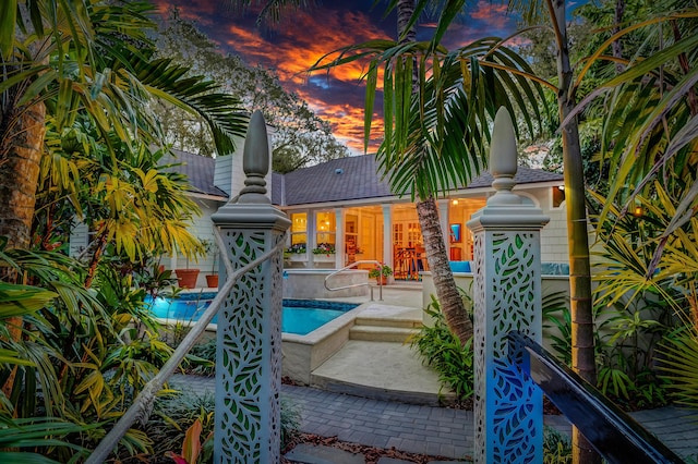 6000 Eagles Nest Dr, Jupiter, FL 33458 - back of property with a patio area, an outdoor pool, and roof with shingles