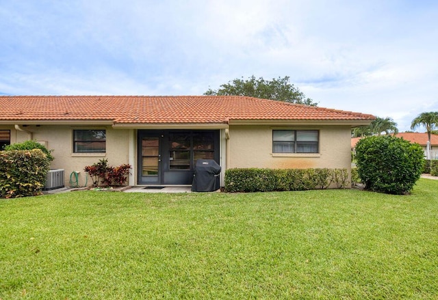 4600 Wildwood Tree A Ln Unit A, Boynton Beach, FL 33436 - rear view of house with stucco siding, central AC, a tiled roof, and a yard