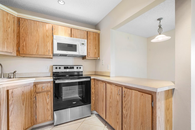 521 Shady Pine Way Unit C2, Greenacres, FL 33415 - kitchen with white microwave, stainless steel range with electric stovetop, a peninsula, light countertops, and a textured ceiling